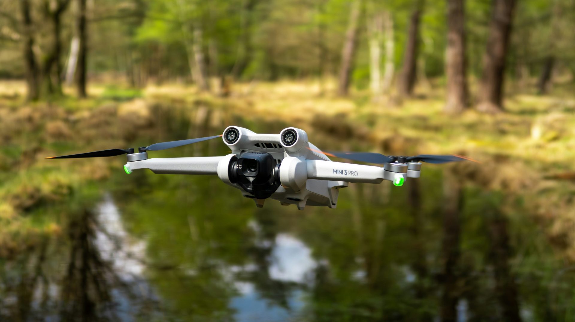 a white and black remote control flying over a forest