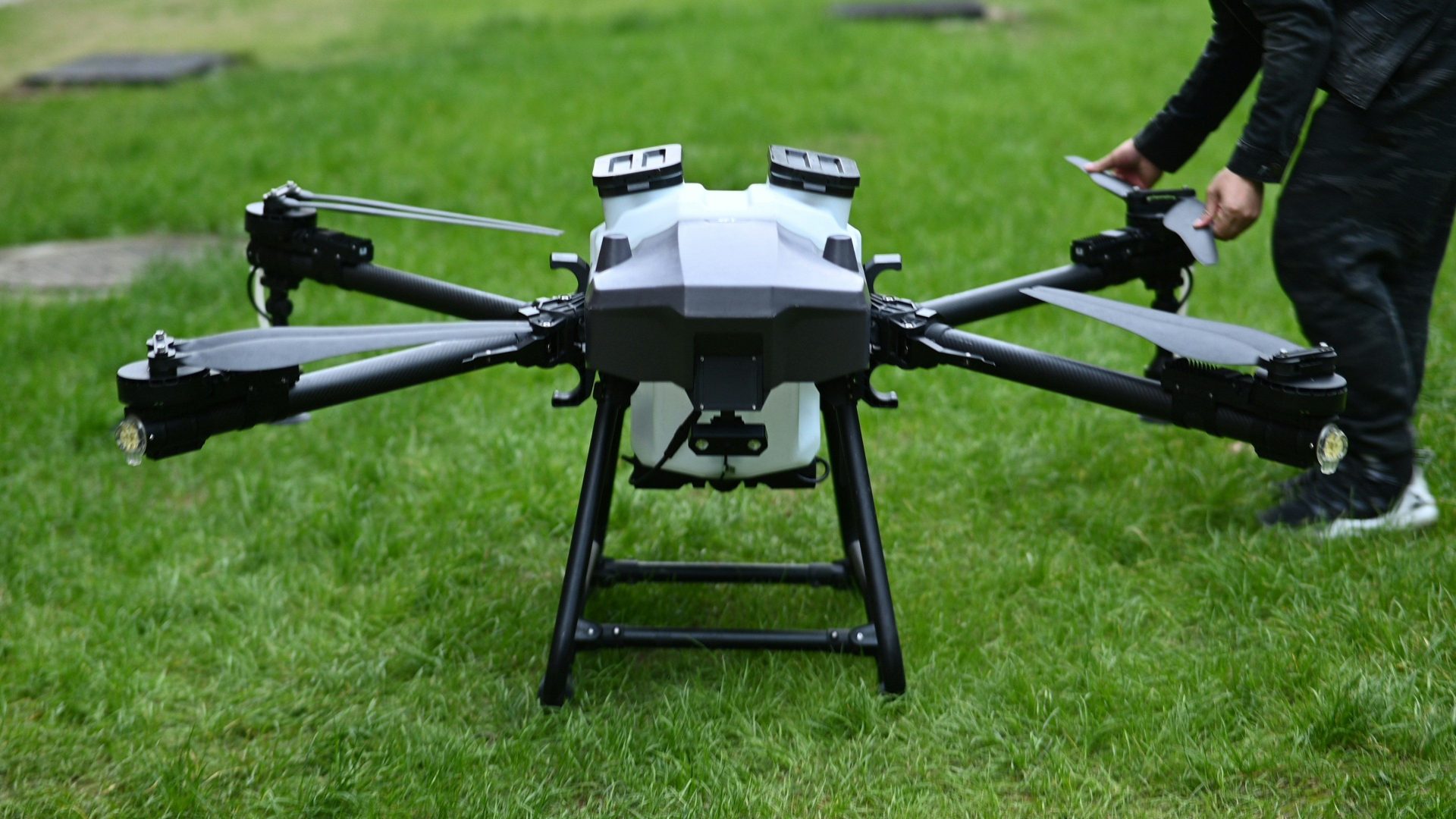 A man standing next to a black and white flying device